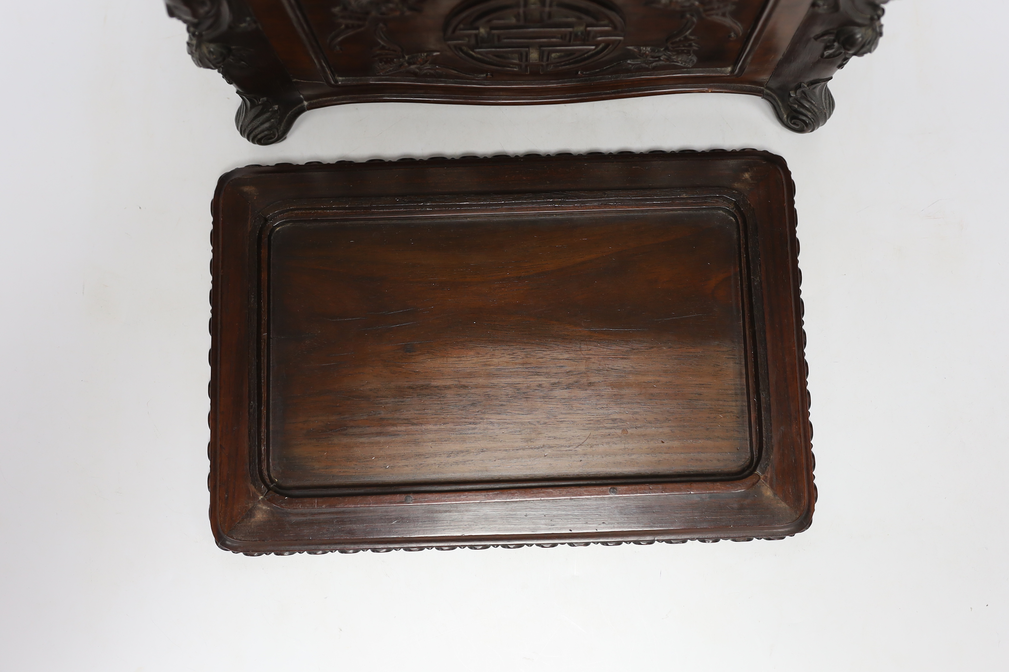 An early 20th century Chinese hongmu wood casket with removable lid and figurative heads on each corner, raised on four feet with G.A.L. carved into the lid, 30cm wide, 20.5cm deep, 20cm high